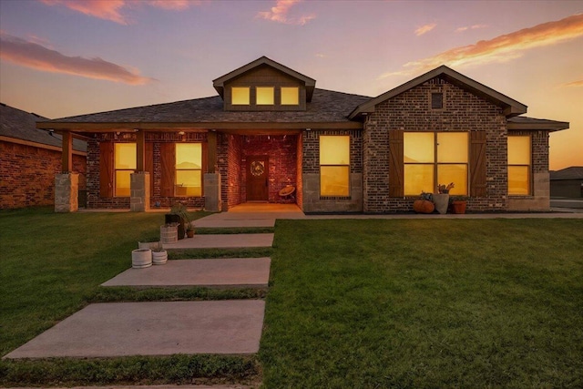 7502 103rd St, Lubbock, TX 79424 - view of front of home with a front yard and brick siding