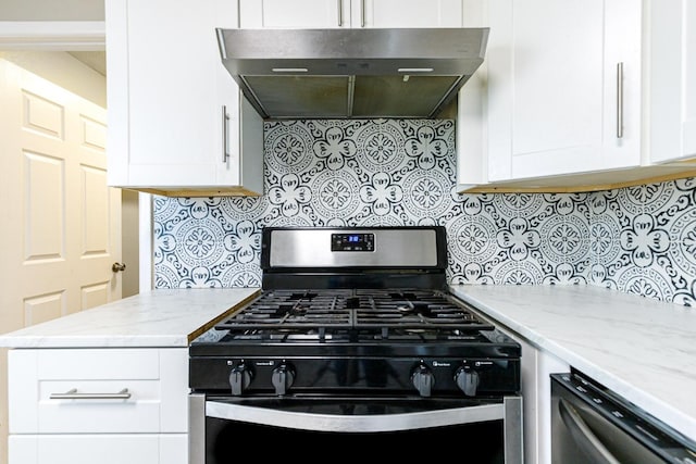 kitchen featuring light stone countertops, black gas range oven, white cabinets, and range hood