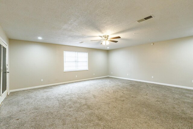 spare room featuring a textured ceiling, carpet floors, and ceiling fan