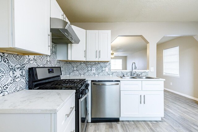 kitchen featuring sink, exhaust hood, tasteful backsplash, appliances with stainless steel finishes, and white cabinets