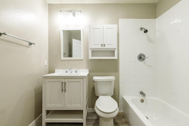 full bathroom featuring vanity, wood-type flooring, tiled shower / bath, and toilet