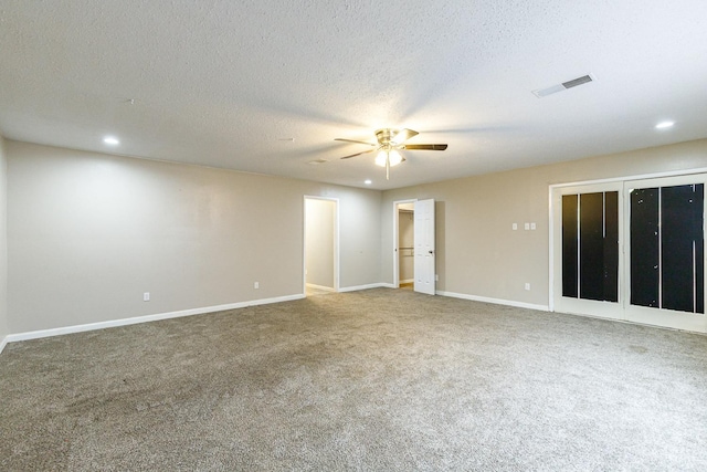 empty room with carpet, a textured ceiling, and ceiling fan