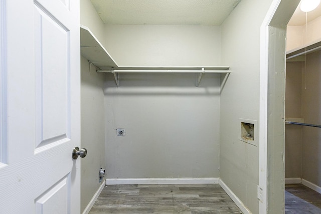 washroom featuring hookup for a washing machine, electric dryer hookup, and dark hardwood / wood-style flooring