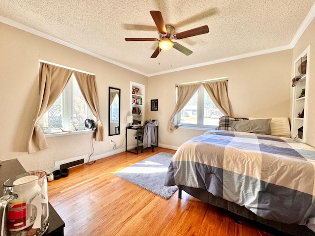 bedroom with hardwood / wood-style flooring, ceiling fan, crown molding, and a textured ceiling