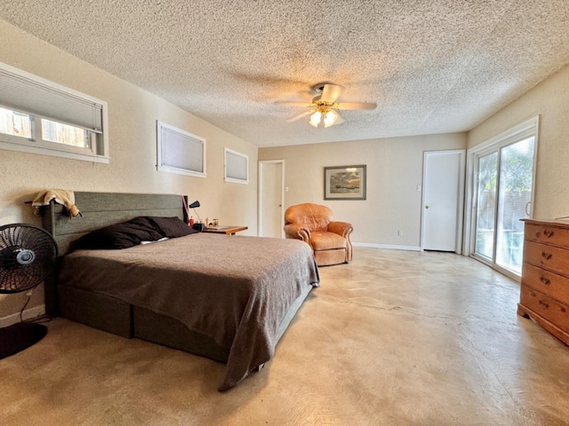 bedroom featuring ceiling fan, access to exterior, and a textured ceiling