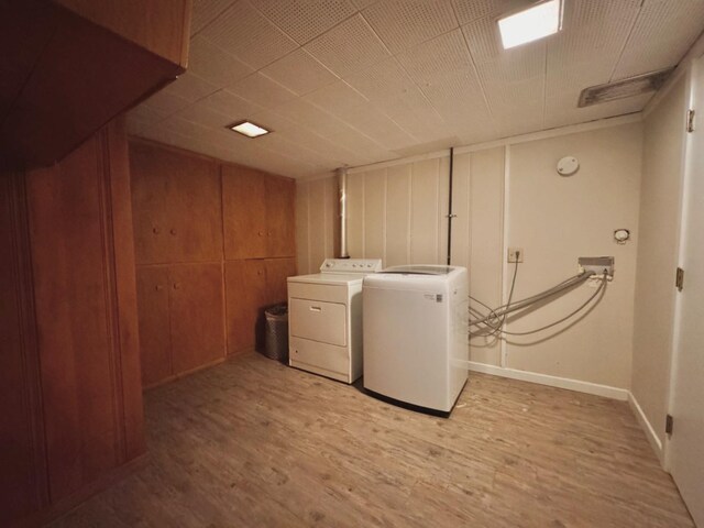 washroom with washer hookup and light hardwood / wood-style flooring