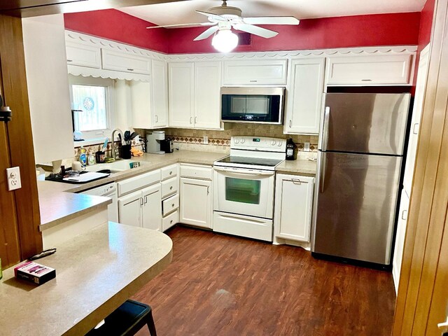 kitchen with dark hardwood / wood-style floors, sink, white cabinets, ceiling fan, and white appliances