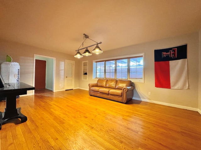 living room featuring lofted ceiling and hardwood / wood-style flooring