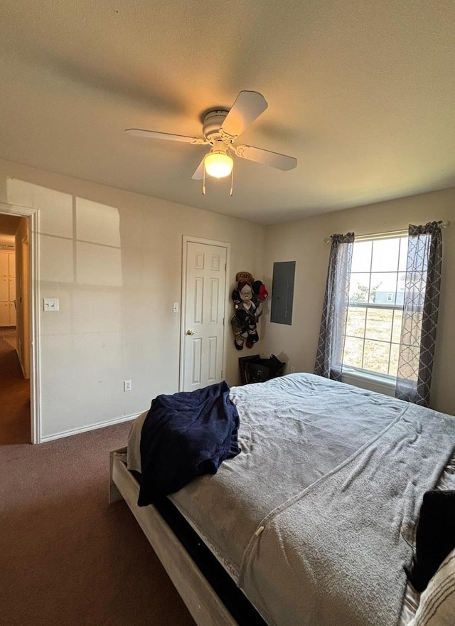 carpeted bedroom featuring electric panel and ceiling fan