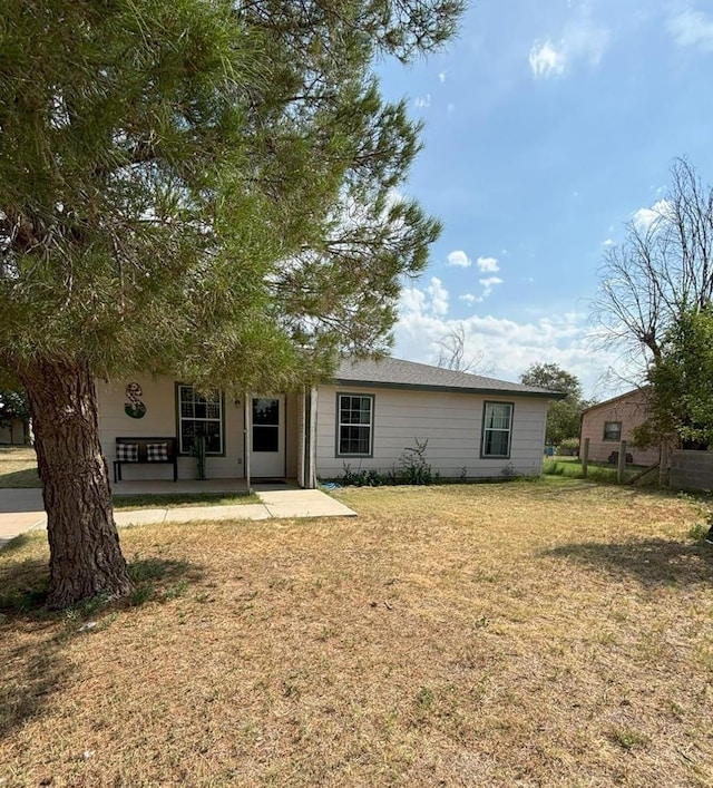 view of front of property with a patio area and a front lawn