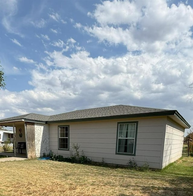 view of side of home featuring a lawn