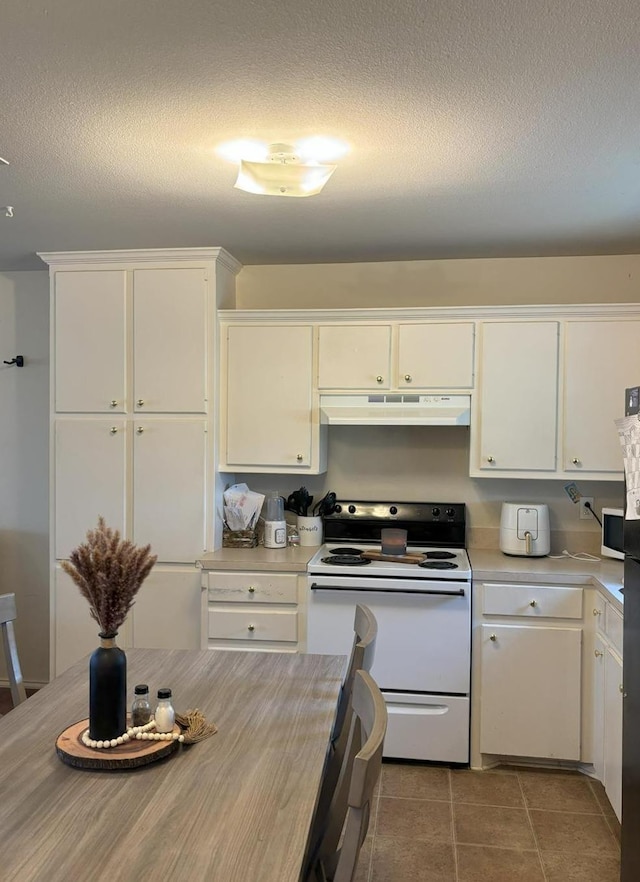 kitchen with white cabinetry, white appliances, tile patterned flooring, and a textured ceiling