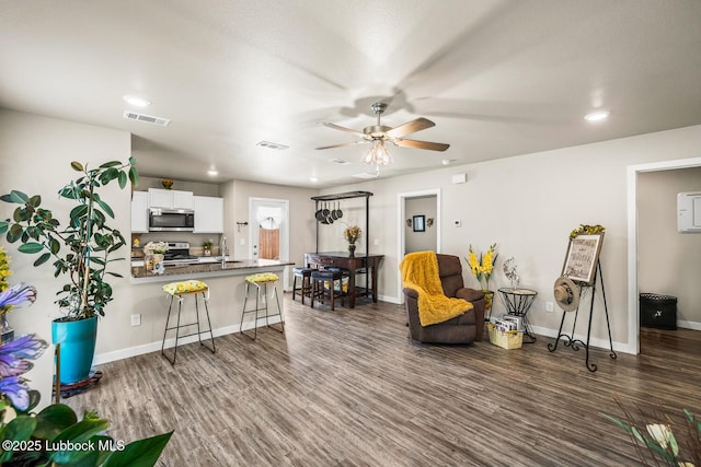 7533 33rd St, Lubbock, TX 79407 - living room with a ceiling fan, dark wood-type flooring, baseboards, and recessed lighting