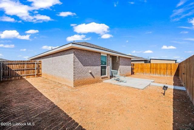 7533 33rd St, Lubbock, TX 79407 - back of property with a fenced backyard, a patio area, and brick siding