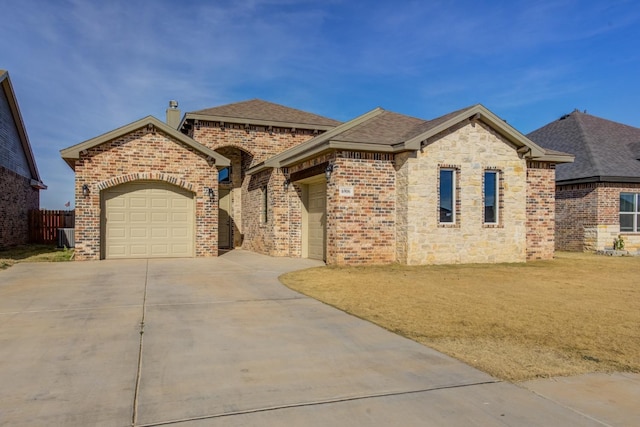 view of front facade with a garage and a front yard