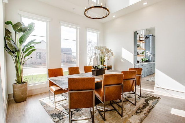 dining area featuring an inviting chandelier, light hardwood / wood-style flooring, and a healthy amount of sunlight