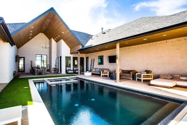 back of house with outdoor lounge area and a patio