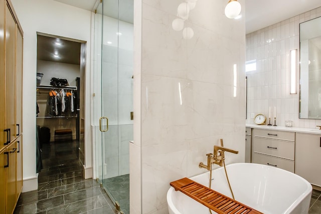 bathroom with shower with separate bathtub, tile walls, and vanity