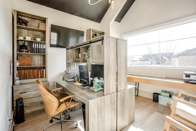 office area featuring lofted ceiling and light hardwood / wood-style flooring