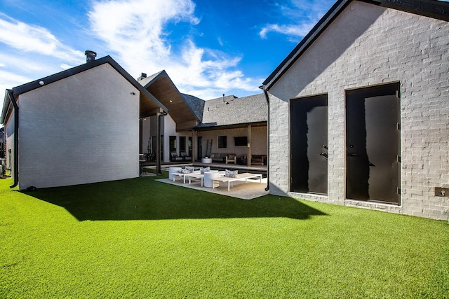 back of property featuring a lawn and a patio area