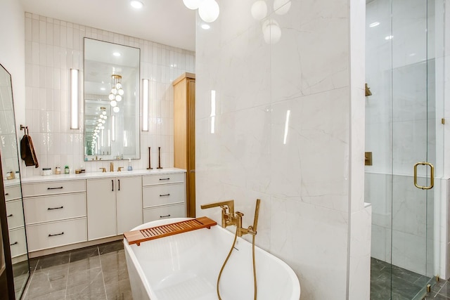 bathroom with vanity, independent shower and bath, and tile walls