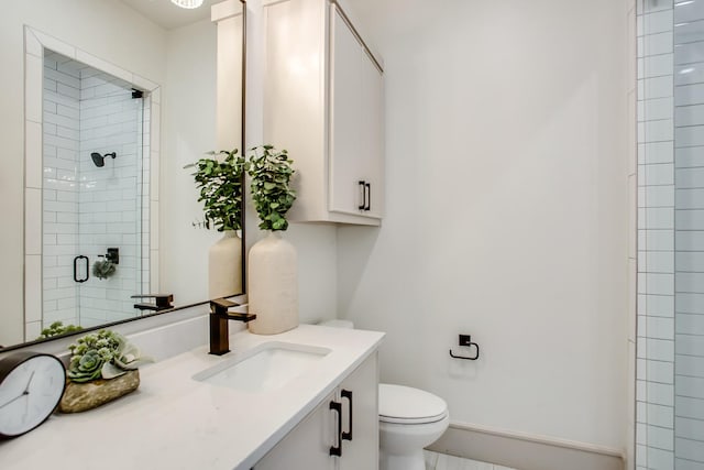 bathroom featuring vanity, toilet, and walk in shower