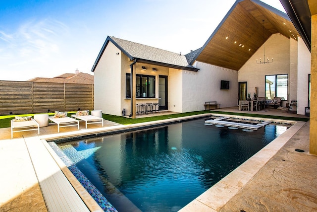 view of swimming pool featuring an in ground hot tub, an outdoor bar, and a patio area