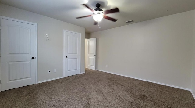 unfurnished bedroom featuring carpet flooring, visible vents, ceiling fan, and baseboards