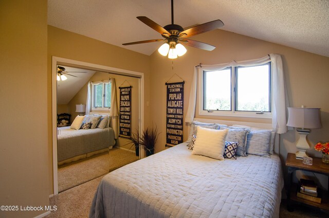 12220 Chicago Ave, Lubbock, TX 79424 - bedroom with lofted ceiling, carpet flooring, a closet, a ceiling fan, and a textured ceiling