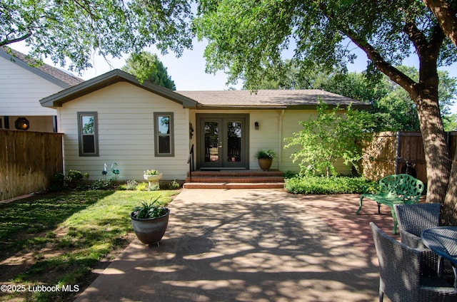 12220 Chicago Ave, Lubbock, TX 79424 - ranch-style home with french doors, a patio, and roof with shingles