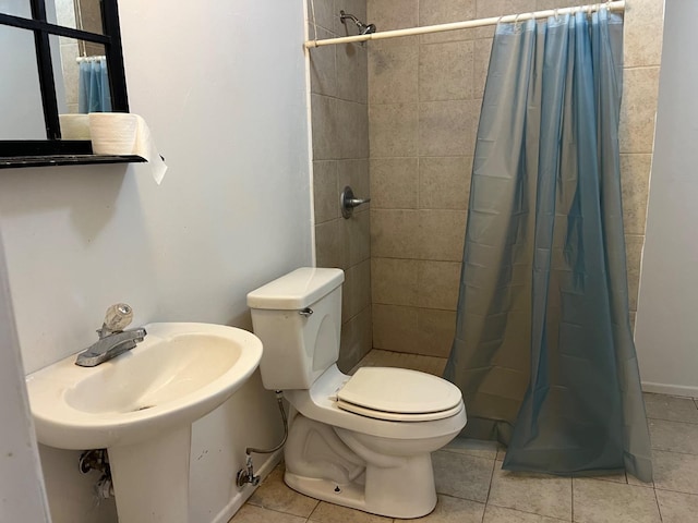 bathroom featuring tile patterned floors, toilet, and walk in shower