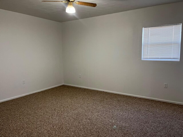 spare room featuring carpet floors and ceiling fan