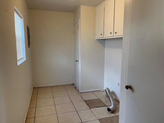 washroom with light tile patterned floors and cabinets