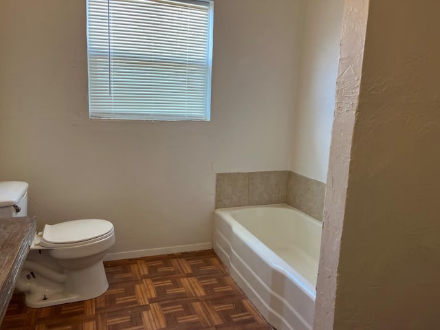 bathroom with parquet floors, toilet, and a washtub