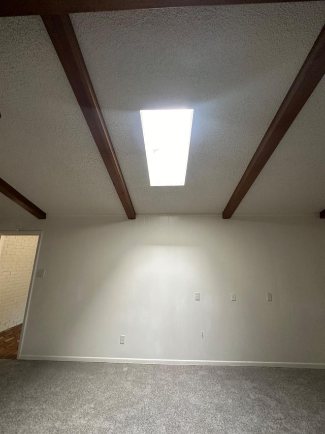 bonus room featuring beam ceiling, carpet, and a textured ceiling