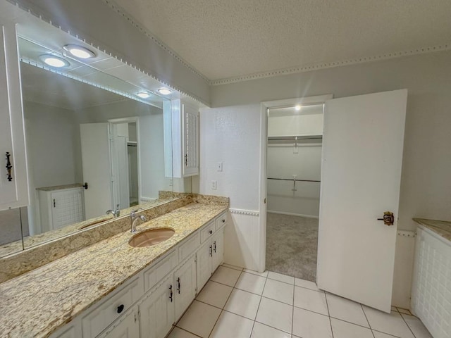 bathroom featuring vanity, tile patterned flooring, and a textured ceiling