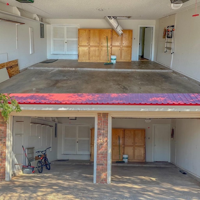 garage with a garage door opener and electric panel