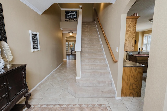 4906 Grinnell St, Lubbock, TX 79416 - stairway featuring arched walkways, crown molding, tile patterned flooring, and baseboards