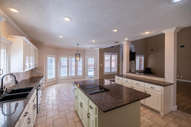 544 S US Highway 87, Wilson, TX 79381 - kitchen featuring decorative columns, crown molding, a sink, baseboards, and black electric stovetop