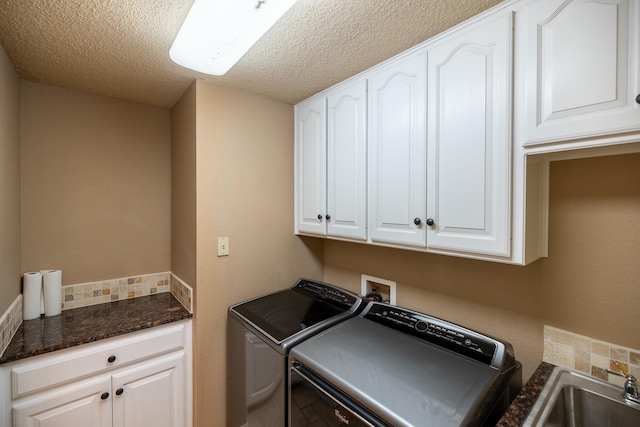544 S US Highway 87, Wilson, TX 79381 - laundry room featuring a sink, a textured ceiling, cabinet space, and washer and dryer