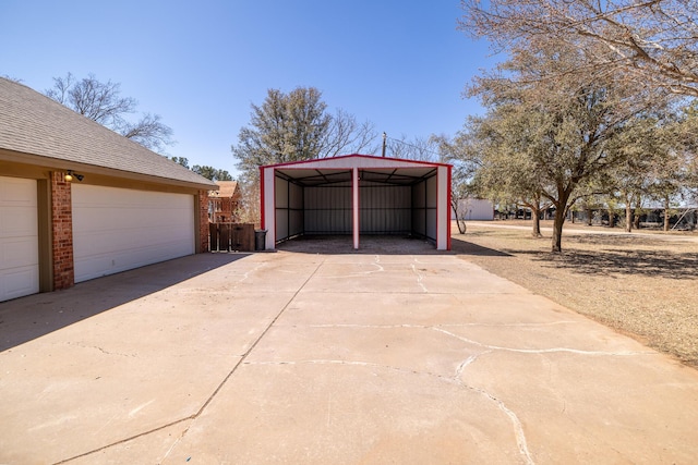 544 S US Highway 87, Wilson, TX 79381 - garage with concrete driveway and a detached carport
