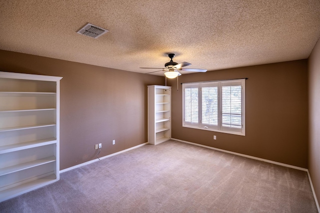 544 S US Highway 87, Wilson, TX 79381 - unfurnished room featuring visible vents, carpet floors, baseboards, ceiling fan, and a textured ceiling