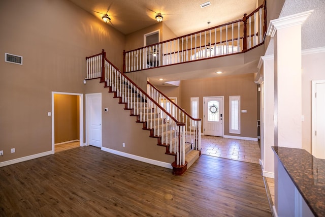 544 S US Highway 87, Wilson, TX 79381 - entryway featuring visible vents, baseboards, a high ceiling, dark wood-style floors, and stairway