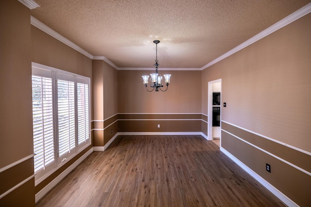 544 S US Highway 87, Wilson, TX 79381 - unfurnished dining area featuring crown molding, a textured ceiling, a chandelier, and dark wood-style floors