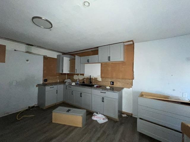 kitchen with sink, dark hardwood / wood-style floors, and white cabinets