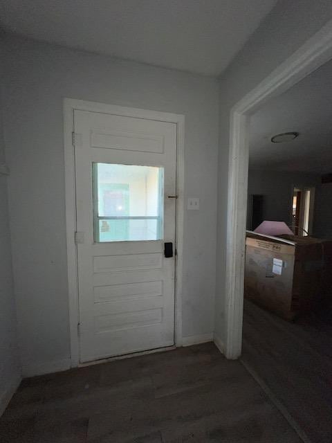 doorway with dark wood-type flooring