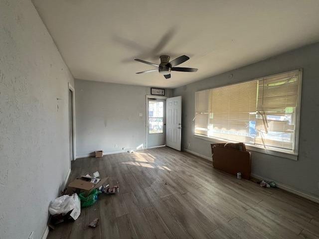 unfurnished room with ceiling fan and wood-type flooring