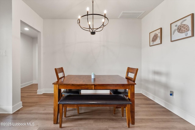 4724 121st Pl, Lubbock, TX 79424 - dining area featuring a chandelier, baseboards, and wood finished floors