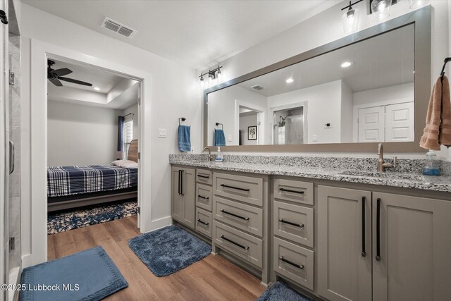 4724 121st Pl, Lubbock, TX 79424 - full bathroom featuring ensuite bath, wood finished floors, double vanity, recessed lighting, and ceiling fan