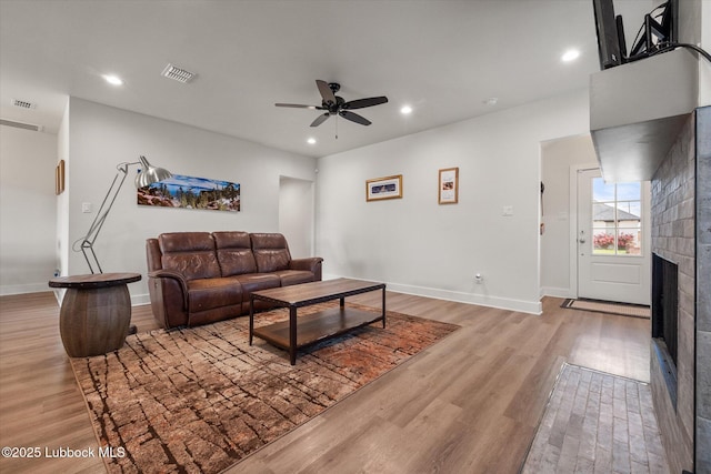 4724 121st Pl, Lubbock, TX 79424 - living area featuring a ceiling fan, light wood-type flooring, a fireplace, recessed lighting, and baseboards